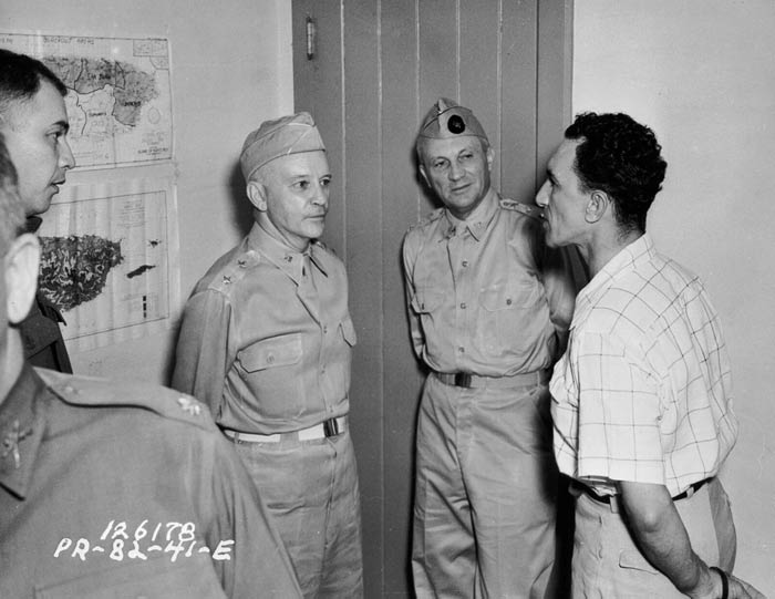 Mr. Gonzalo Soanes, mayor of Caguas, explains how his town conducted blackouts to Lt. Col. F. Parra, Maj. Gen. Collins, and Lt. Gen. Andrews. Puerto Rico. November 1941.  SC 126178